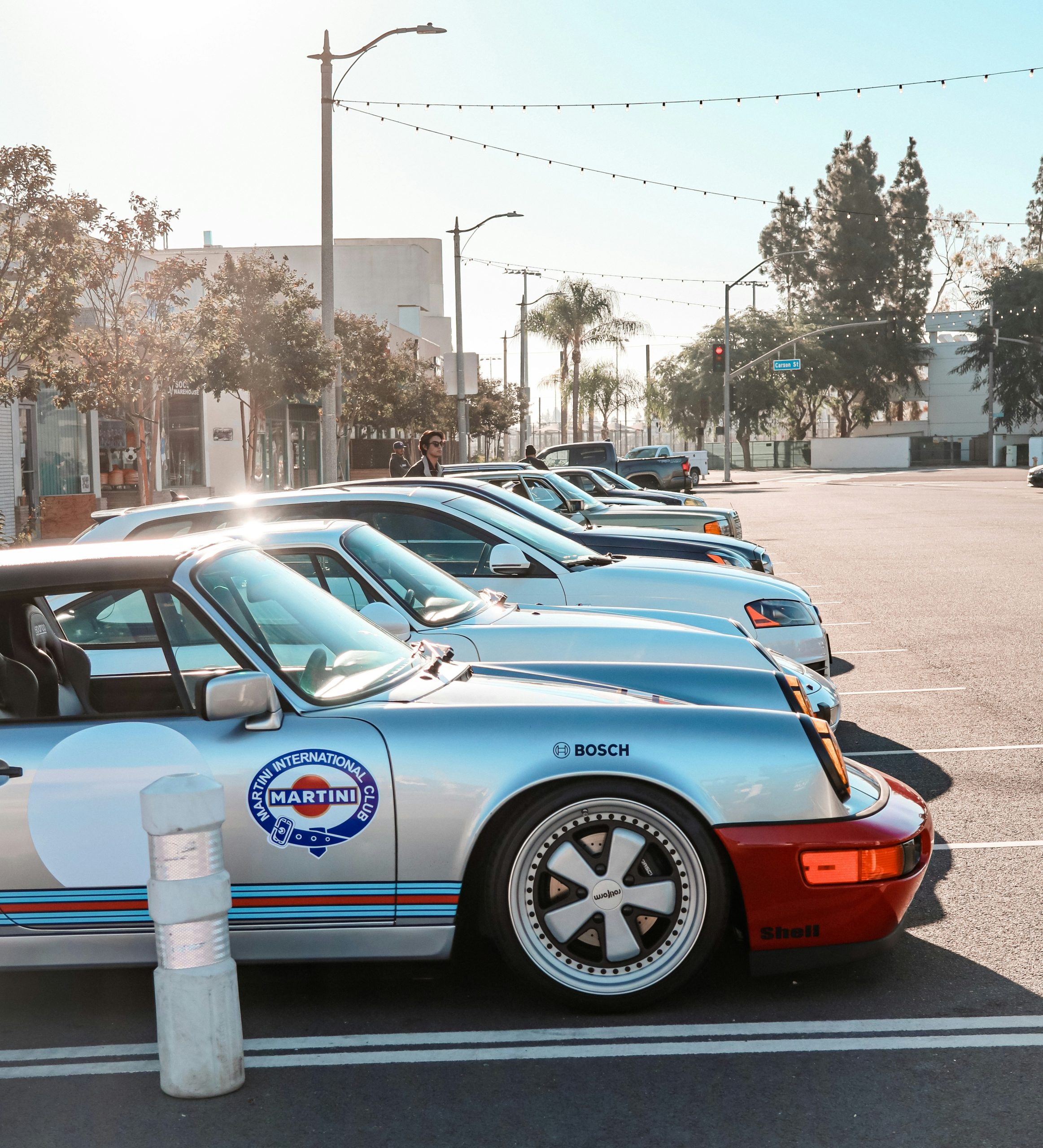 Row of classic cars parked on a sunny city street