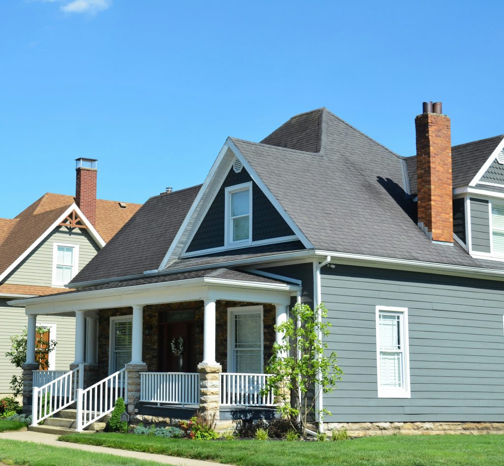 Grey weatherboard family home with a white front porch