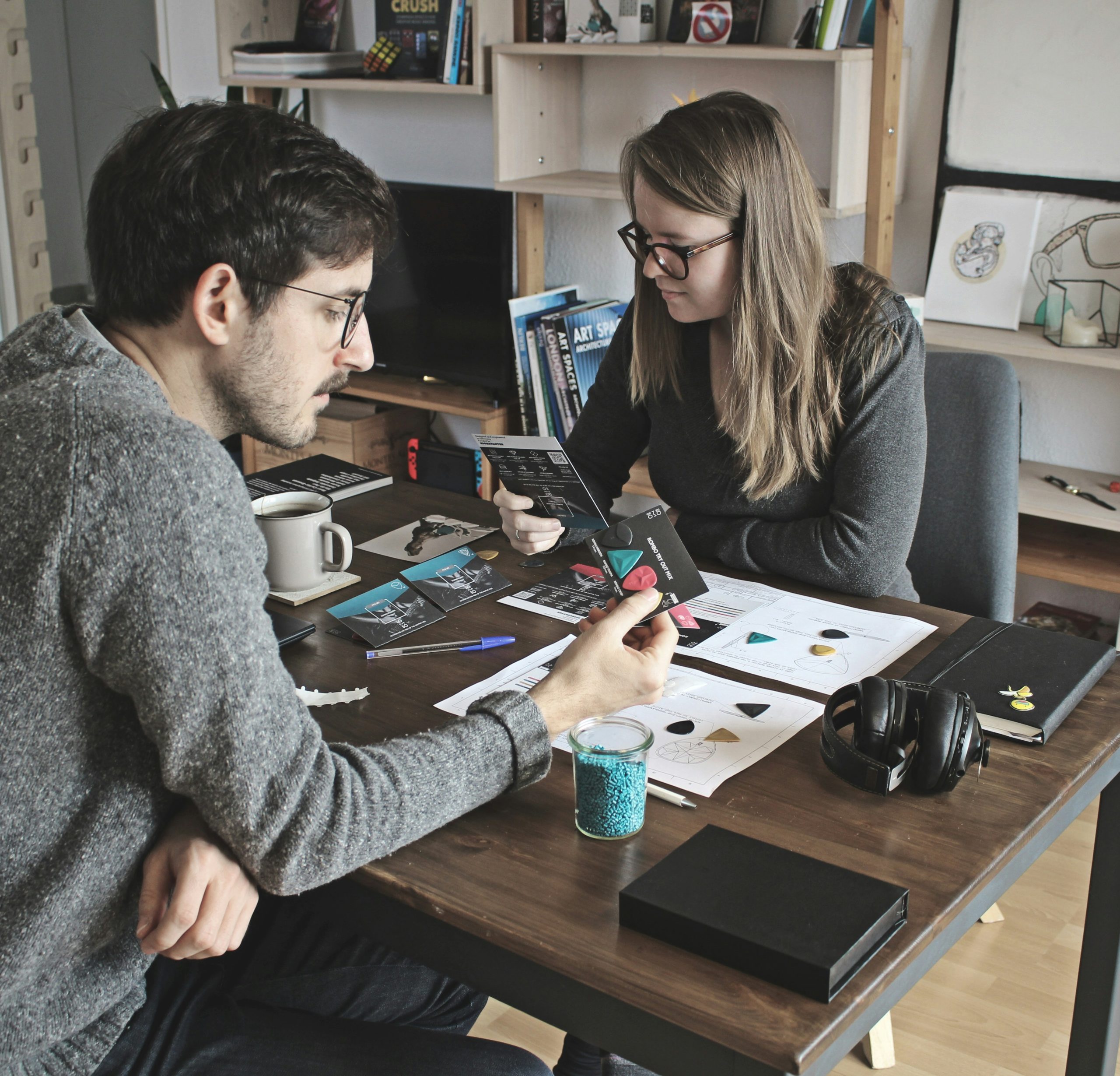 Two small business owners reviewing product samples at a table