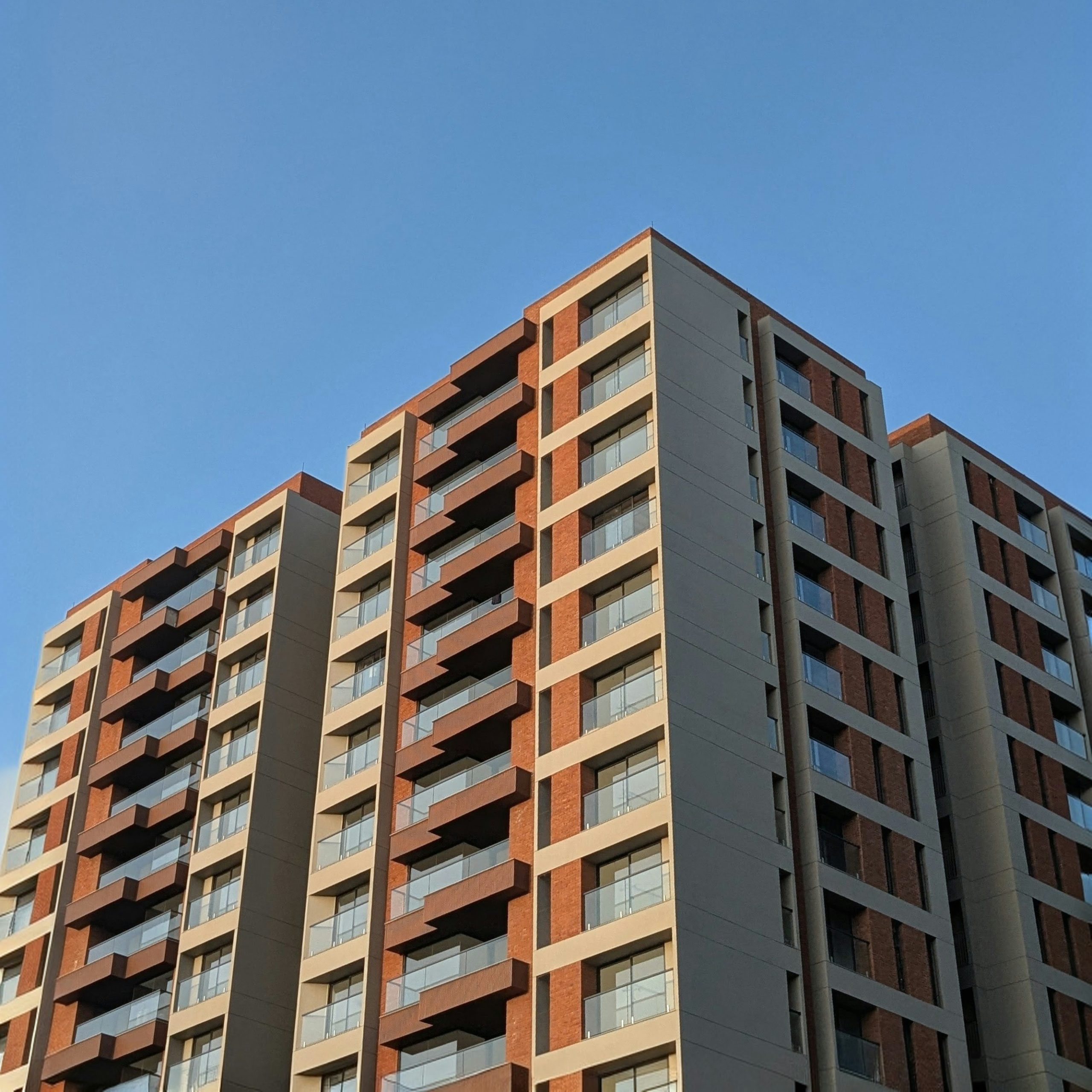 Modern terraced apartment building with rooftop gardens