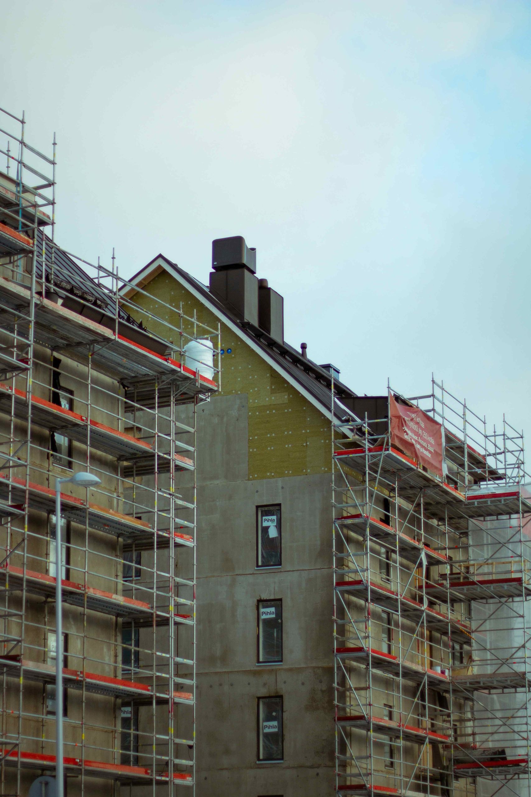 Apartment building under construction surrounded by scaffolding